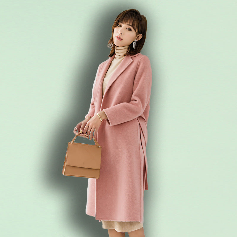 Woman wearing long wool winter coat with belt