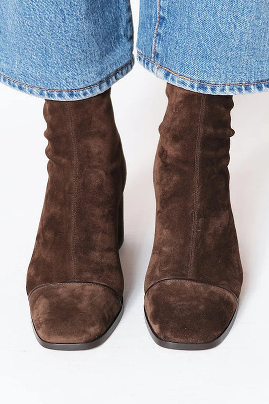 Woman wearing dark brown square toe block heel boots