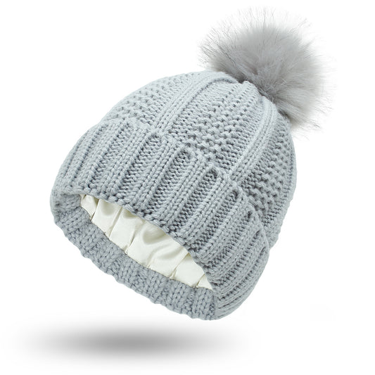 Women's knit beanie with faux fur pom pom