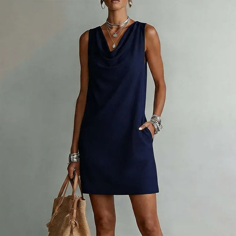 Woman wearing sleeveless mini dress with draped neckline