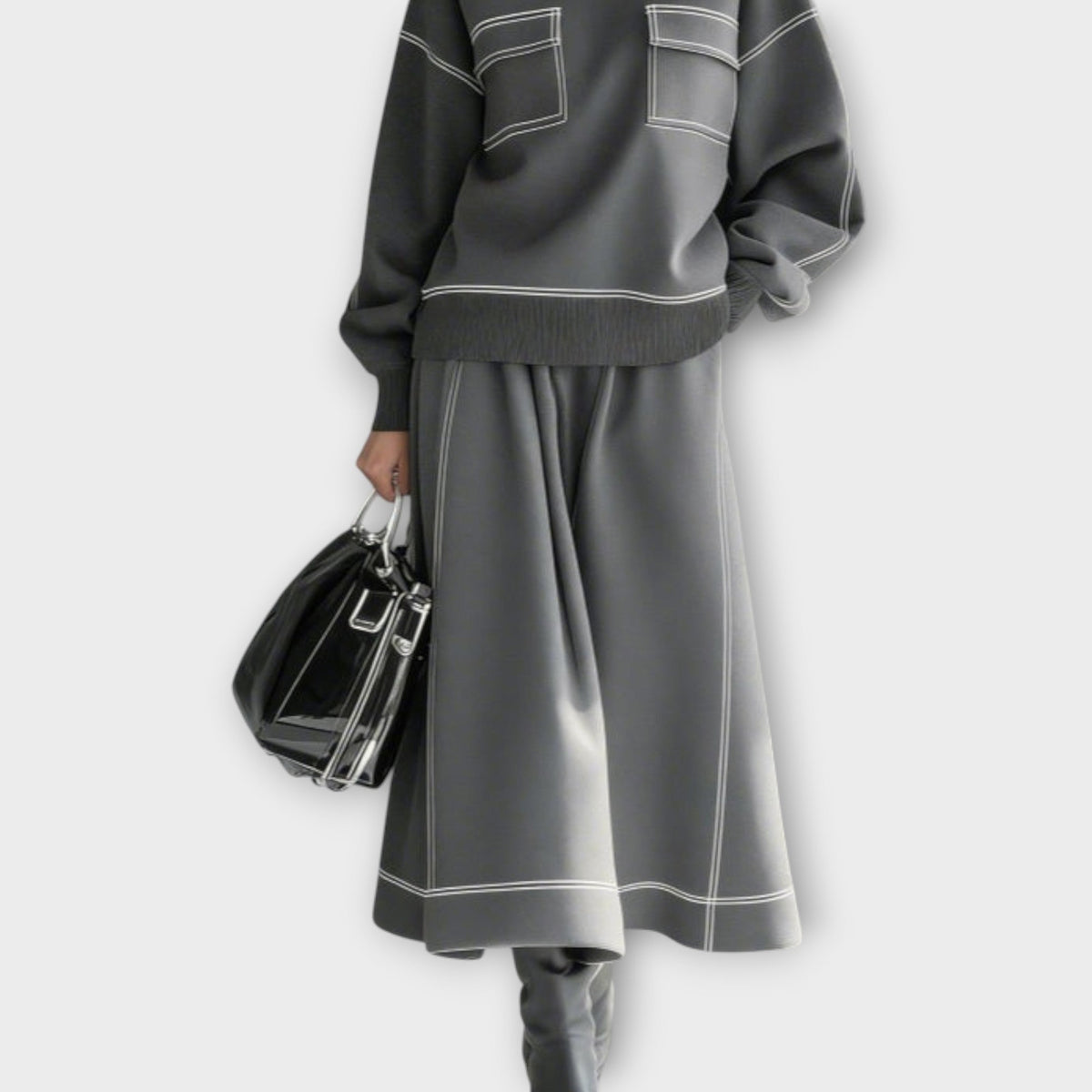 Woman wearing charcoal gray mock neck two-piece skirt set