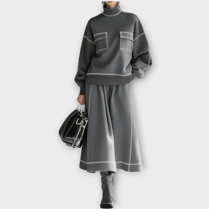 Woman wearing charcoal gray mock neck two-piece skirt set