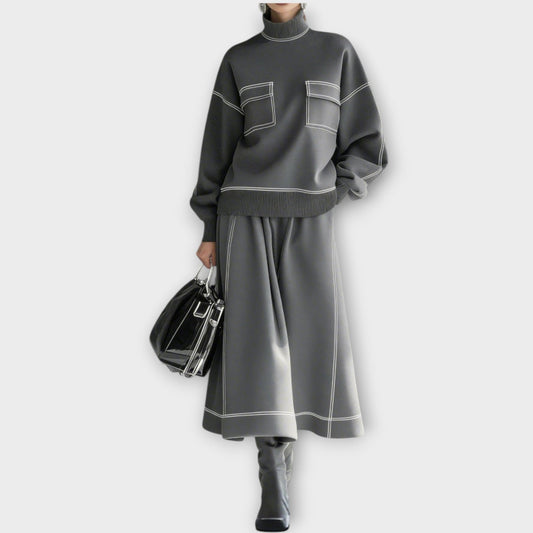 Woman wearing charcoal gray mock neck two-piece skirt set