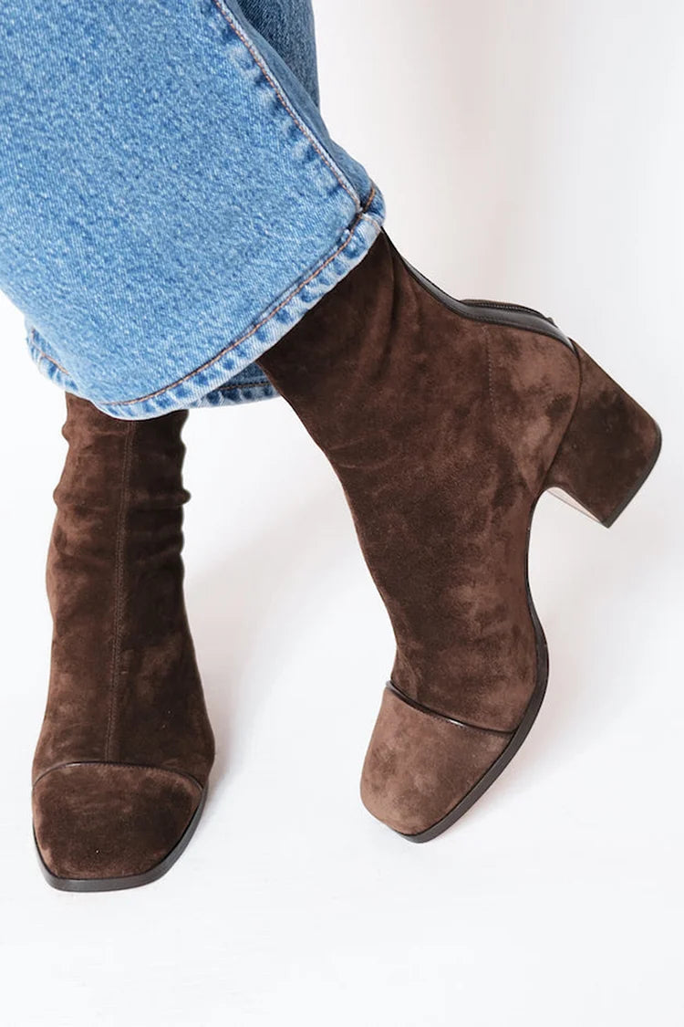 Woman wearing dark brown square toe block heel boots
