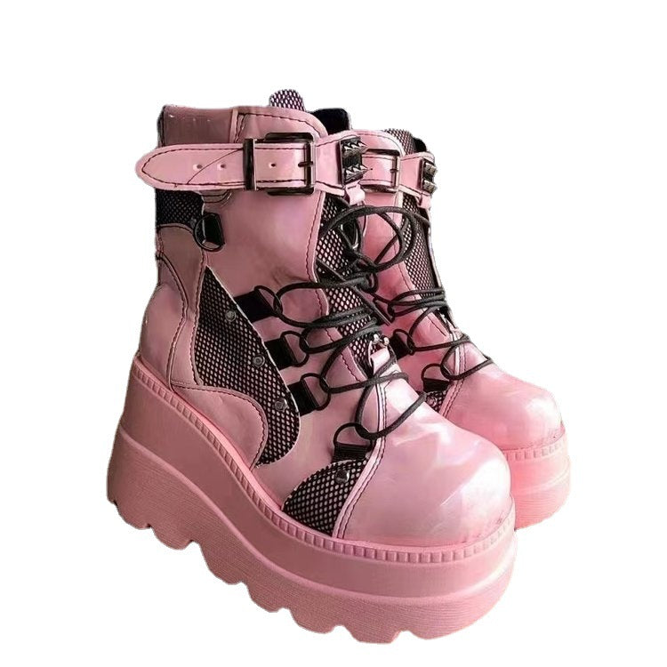 Woman wearing pink platform wedge mid-calf boots