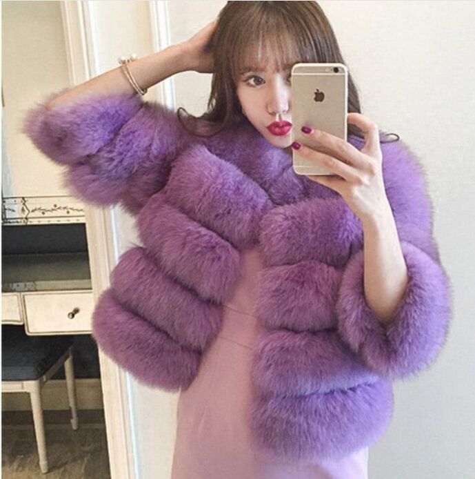 Woman wearing long faux fur winter coat outdoors
