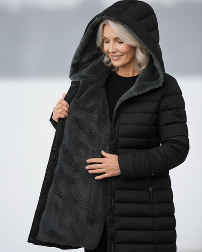 Woman wearing dark green fleece-lined A-line puffer coat