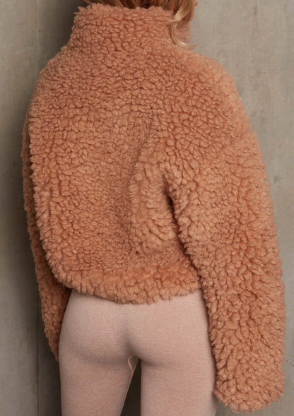 Woman wearing short open-front cardigan jacket indoors