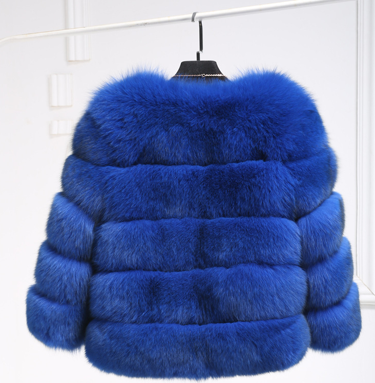 Woman wearing long faux fur winter coat outdoors