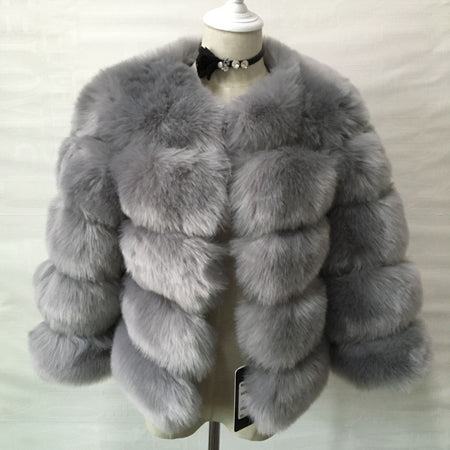 Woman wearing long faux fur winter coat outdoors