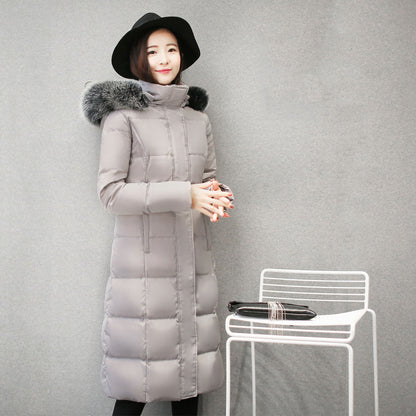 Woman wearing long hooded down jacket with fur collar