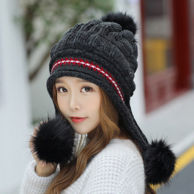 Women's knit beanie with ear flaps and pompom