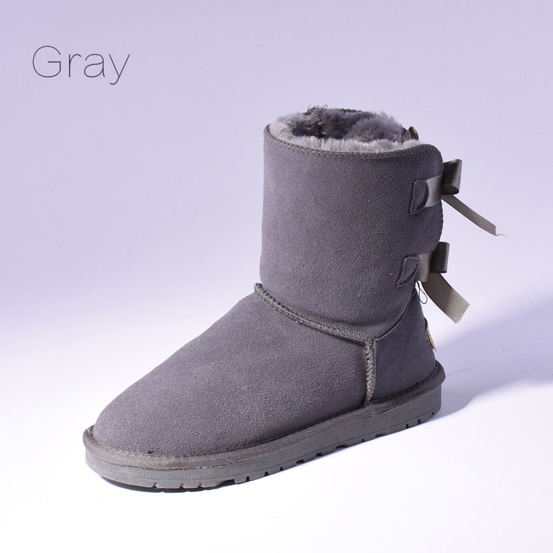Women's mid-calf slip-on snow boots with bow detail