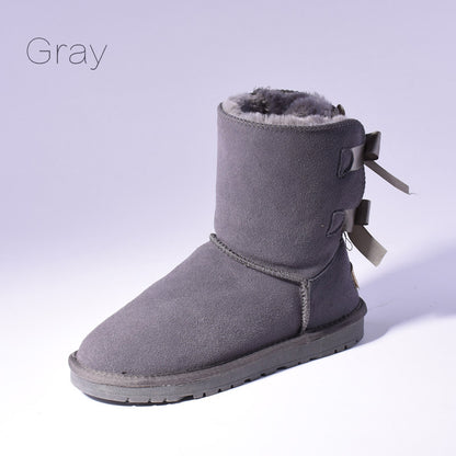 Women's mid-calf slip-on snow boots with bow detail