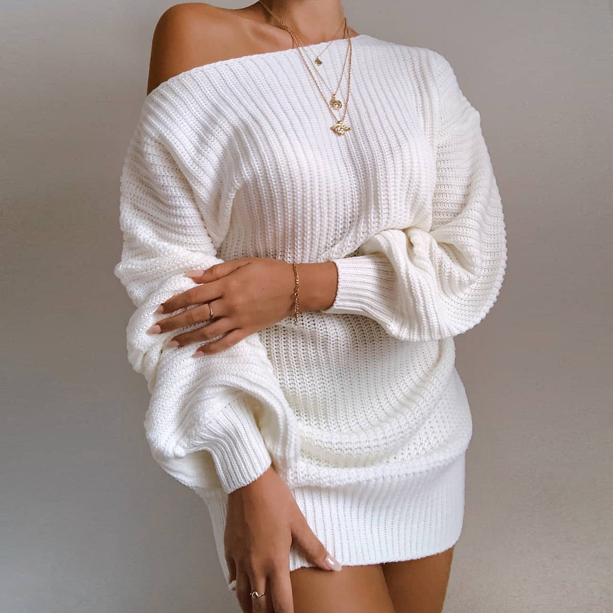 Woman wearing off-shoulder knit sweater dress with long sleeves