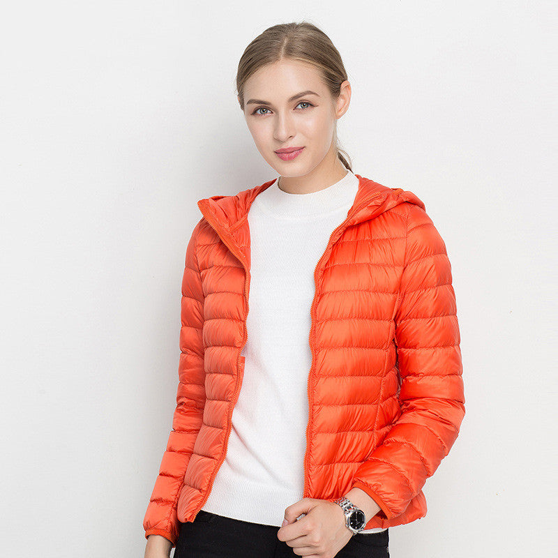 Woman wearing short hooded down jacket with zip front