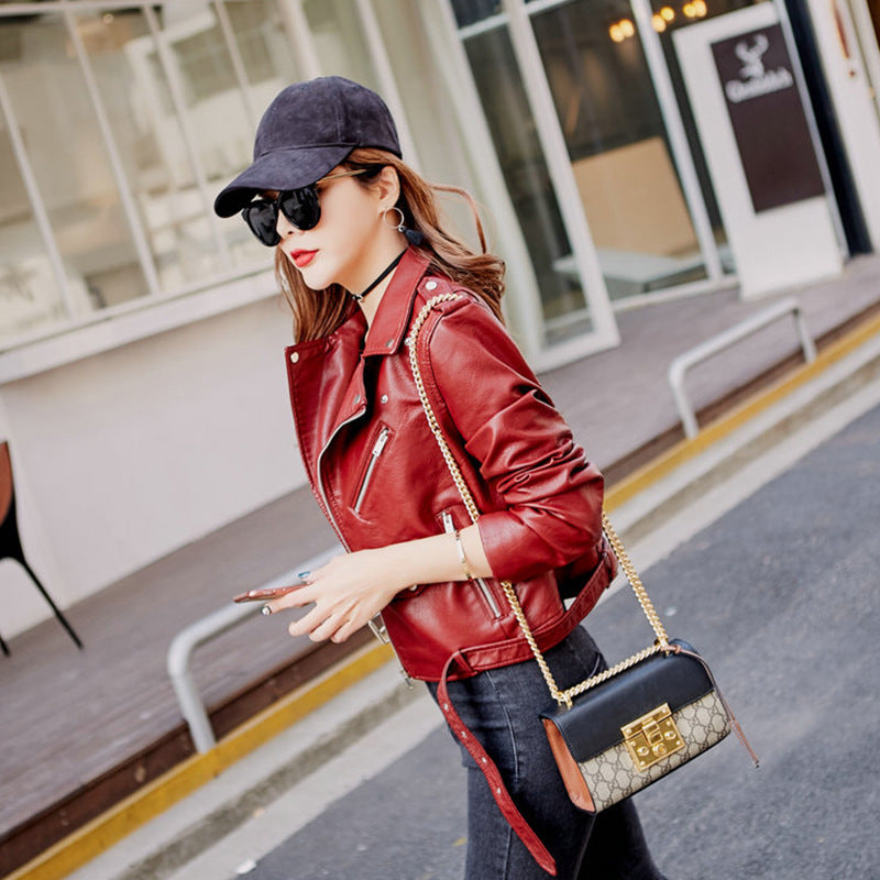 Woman wearing blue faux leather motorcycle jacket