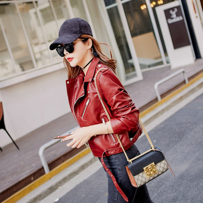 Woman wearing blue faux leather motorcycle jacket