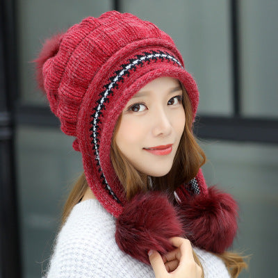 Women's knit beanie with ear flaps and pompom