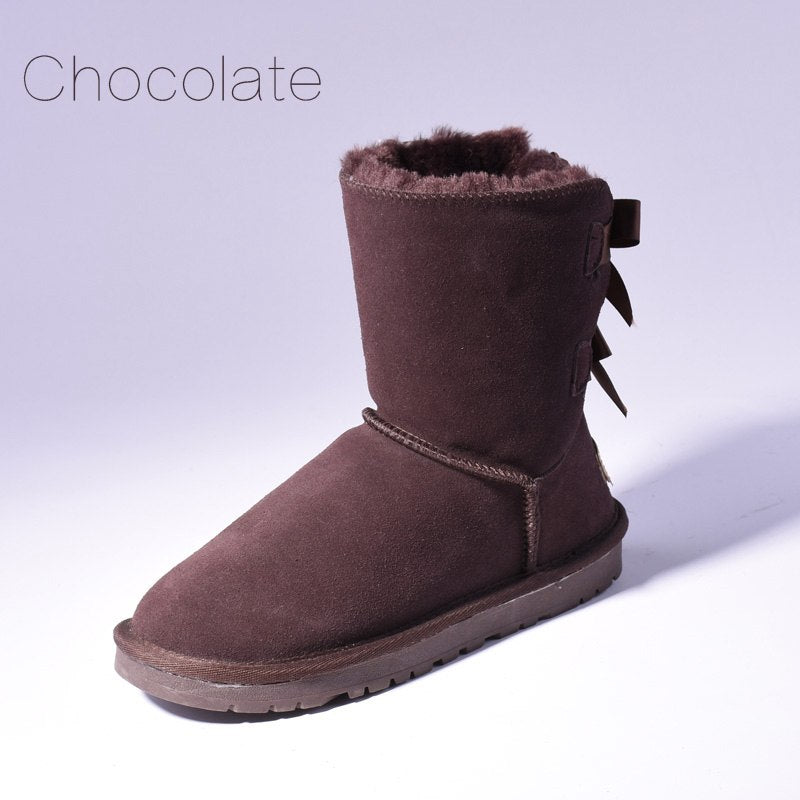 Women's mid-calf slip-on snow boots with bow detail