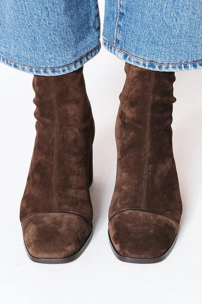 Woman wearing dark brown square toe block heel boots