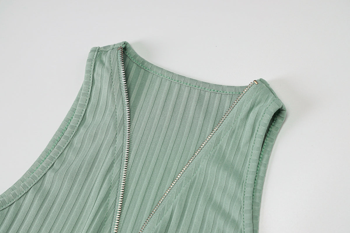 Woman wearing green and pink striped knit sleeveless mini dress