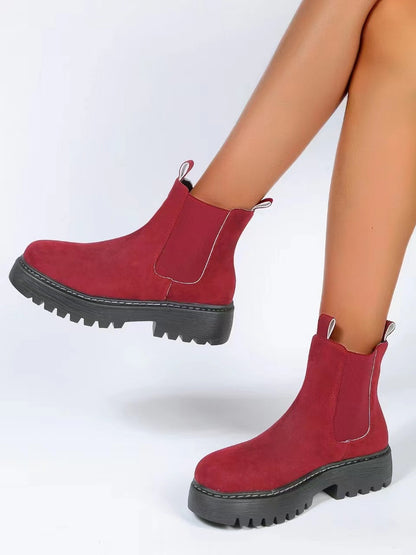 Woman wearing black short Martin boots with jeans