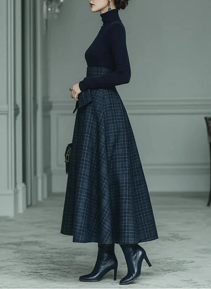 Woman wearing dark blue high-neck top and plaid skirt set