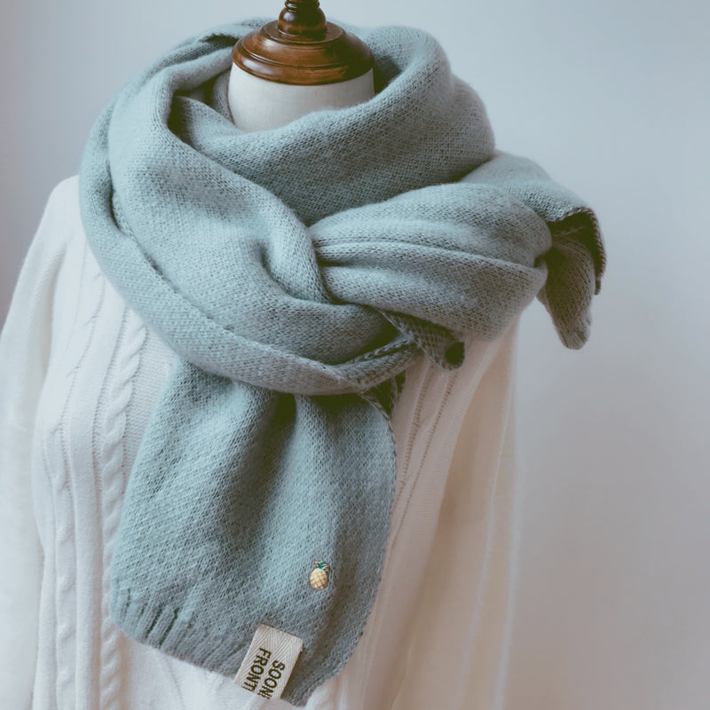Woman wearing long winter scarf in imitation cashmere fabric