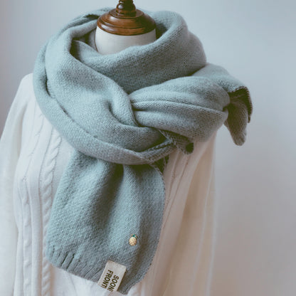 Woman wearing long winter scarf in imitation cashmere fabric