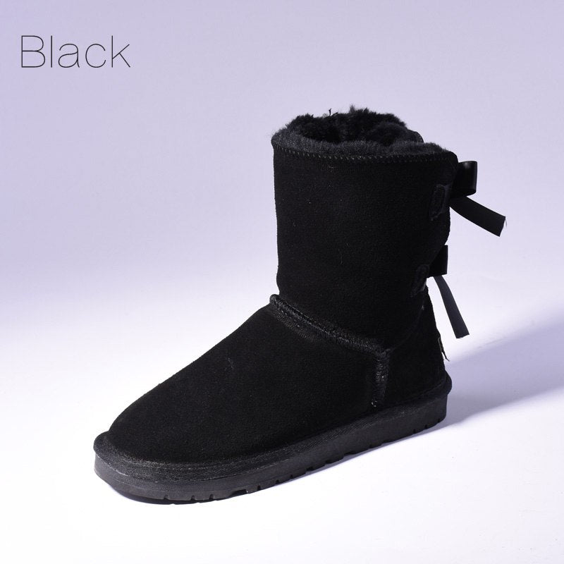 Women's mid-calf slip-on snow boots with bow detail