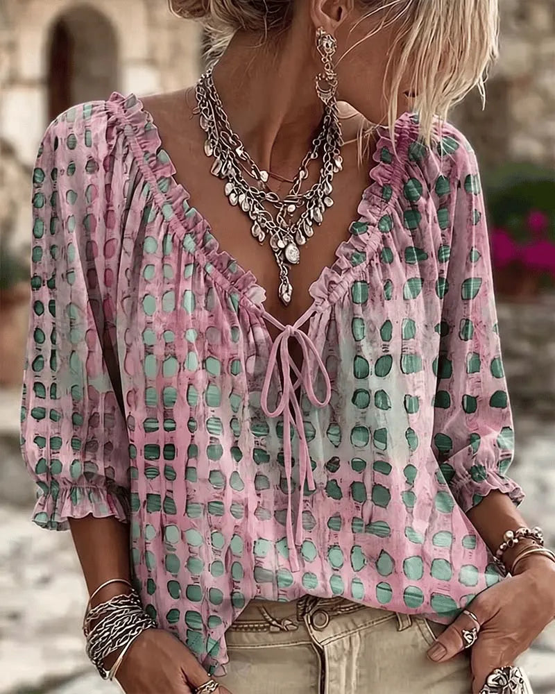 Woman wearing polka dot blouse with V-neck and puff sleeves