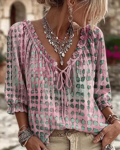 Woman wearing polka dot blouse with V-neck and puff sleeves