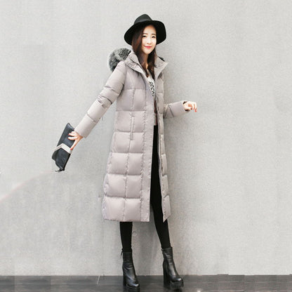 Woman wearing long hooded down jacket with fur collar