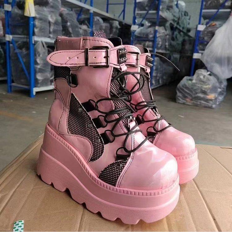 Woman wearing pink platform wedge mid-calf boots
