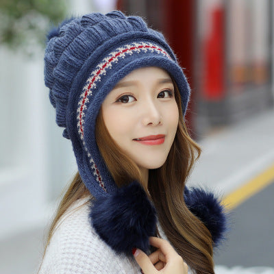 Women's knit beanie with ear flaps and pompom