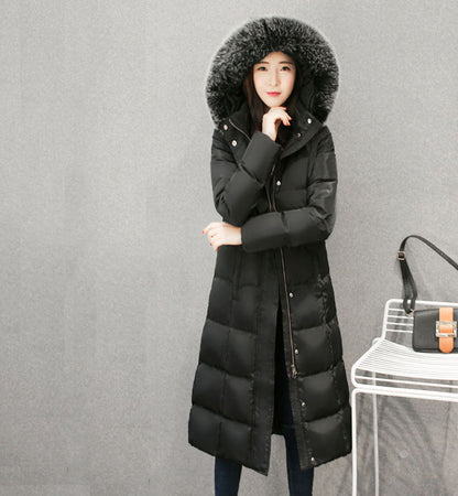 Woman wearing long hooded down jacket with fur collar