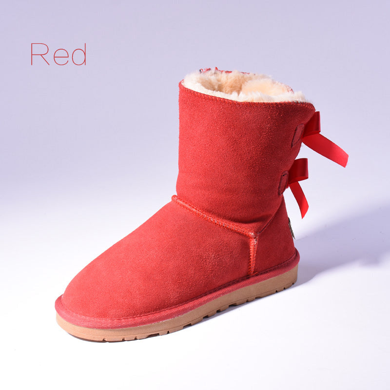 Women's mid-calf slip-on snow boots with bow detail