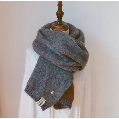Woman wearing long winter scarf in imitation cashmere fabric