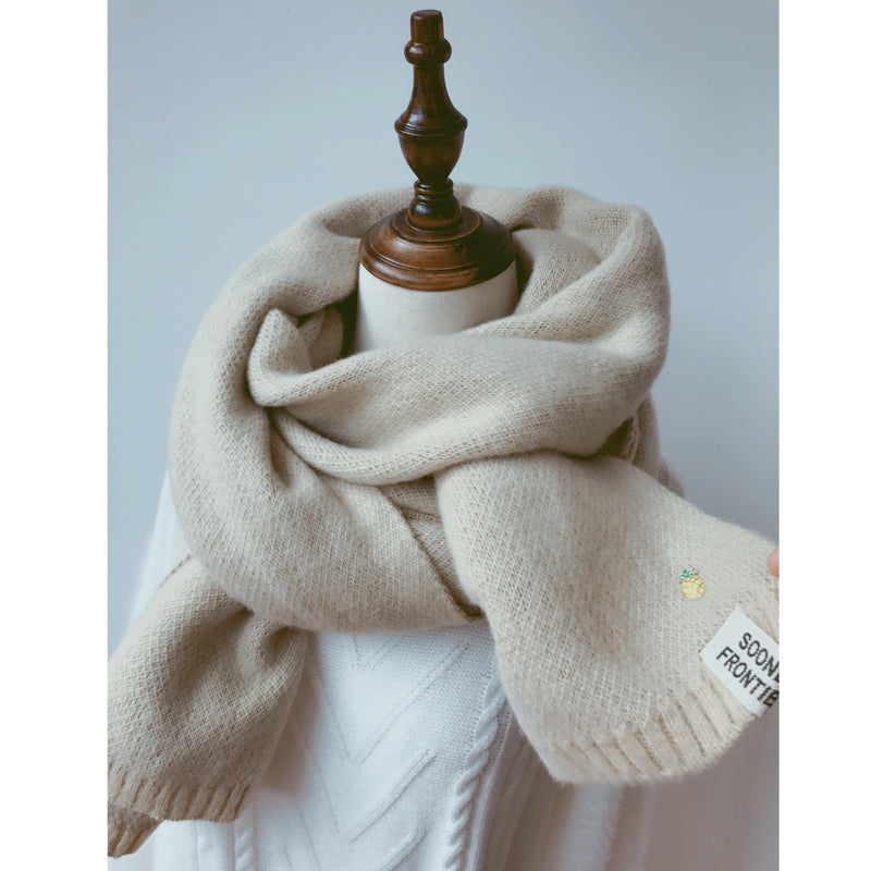 Woman wearing long winter scarf in imitation cashmere fabric