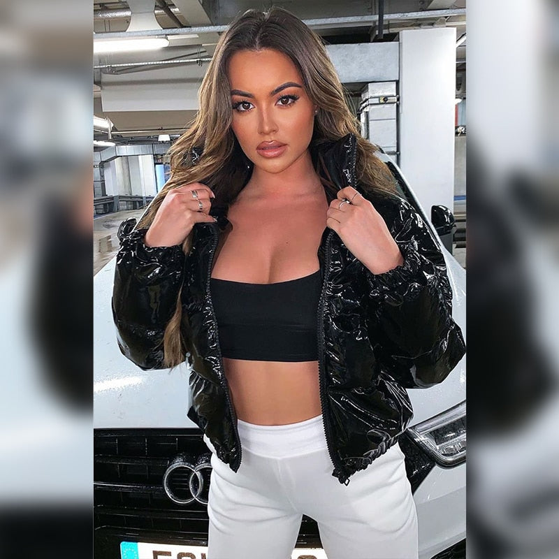 Woman wearing black faux leather puffer jacket with zip front
