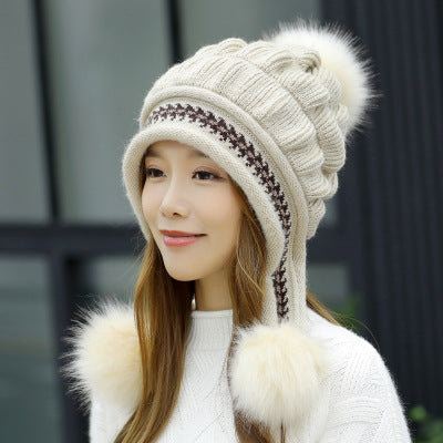 Women's knit beanie with ear flaps and pompom