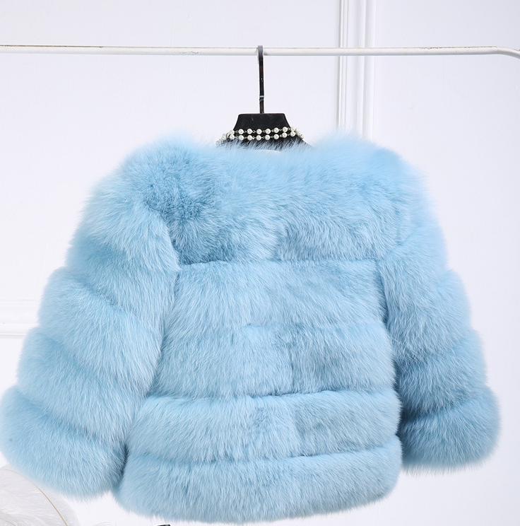 Woman wearing long faux fur winter coat outdoors