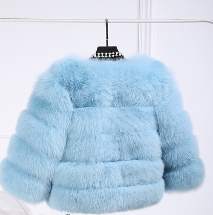 Woman wearing long faux fur winter coat outdoors