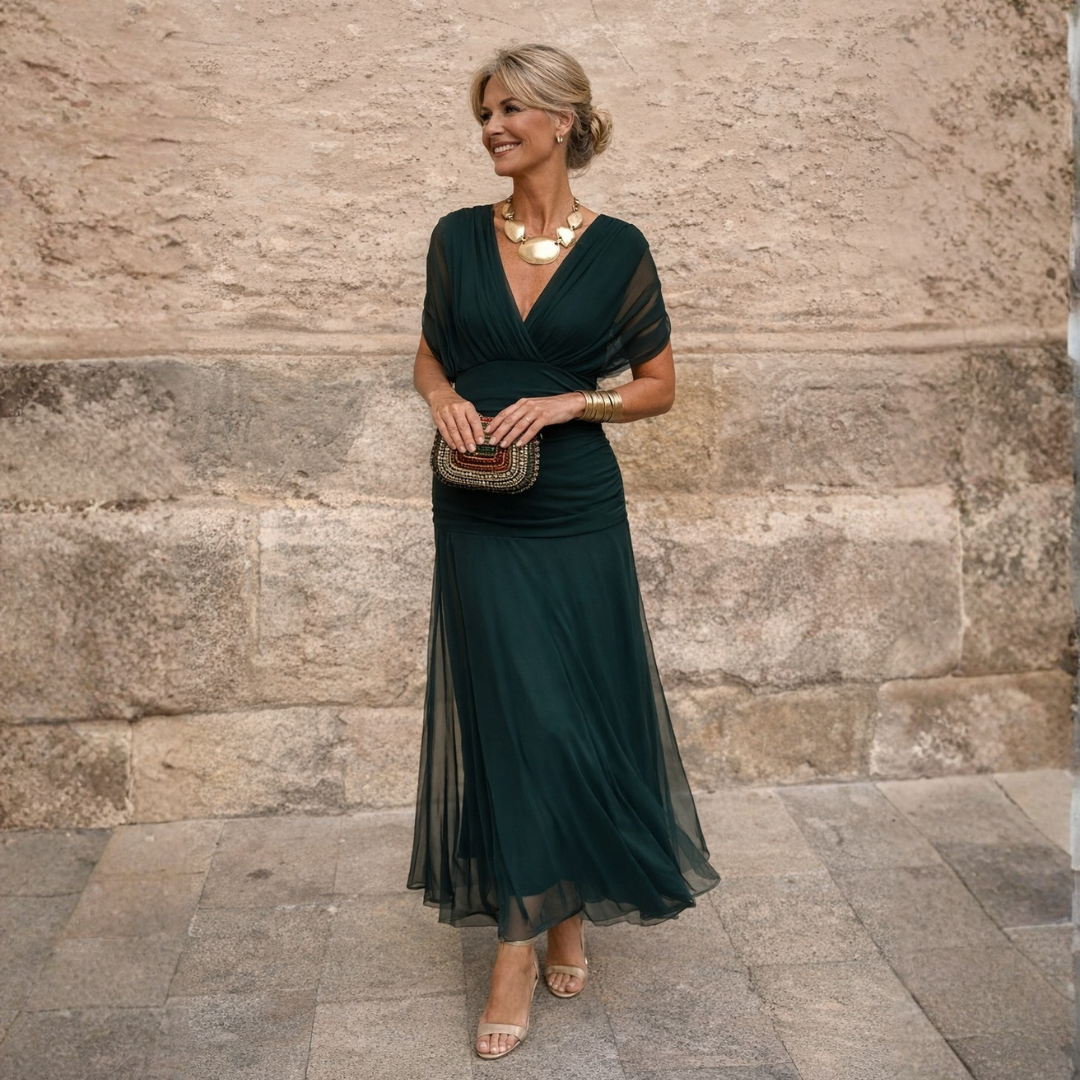 Woman wearing long flowing maxi dress with V-neck
