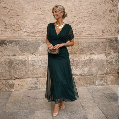 Woman wearing long flowing maxi dress with V-neck