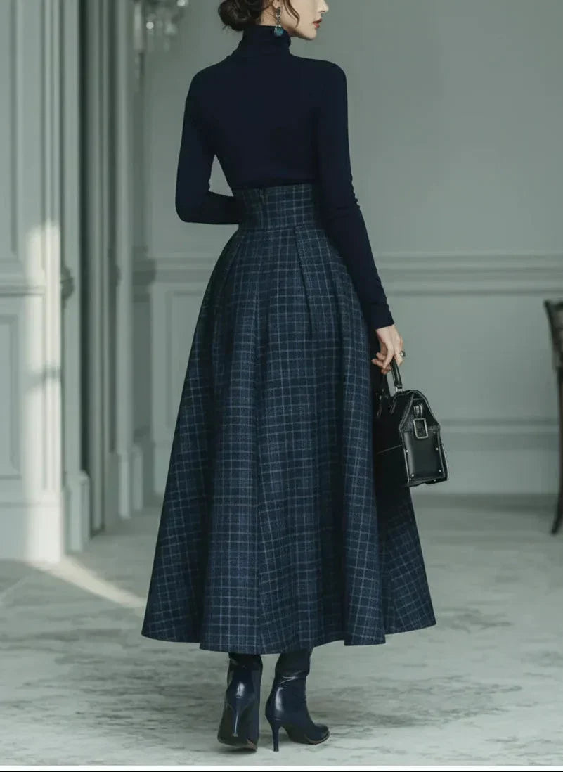 Woman wearing dark blue high-neck top and plaid skirt set