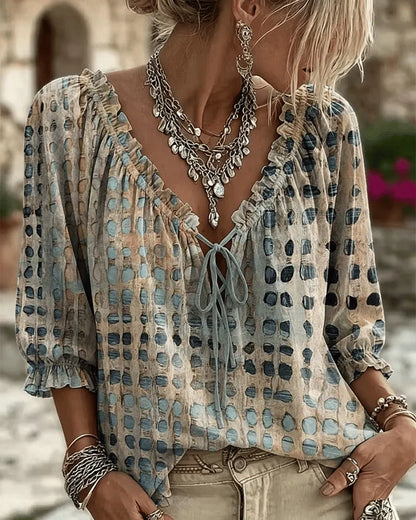 Woman wearing polka dot blouse with V-neck and puff sleeves