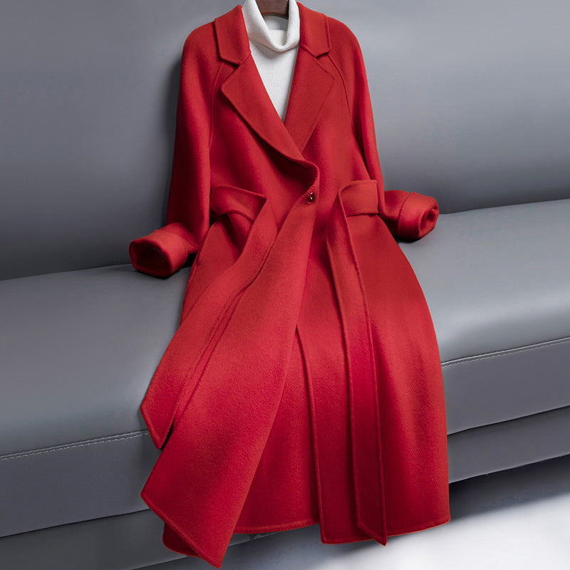 Woman wearing long wool winter coat with belt
