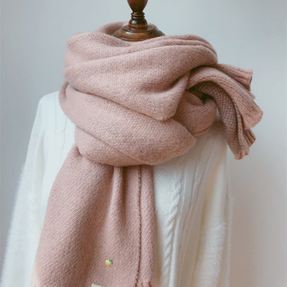 Woman wearing long winter scarf in imitation cashmere fabric